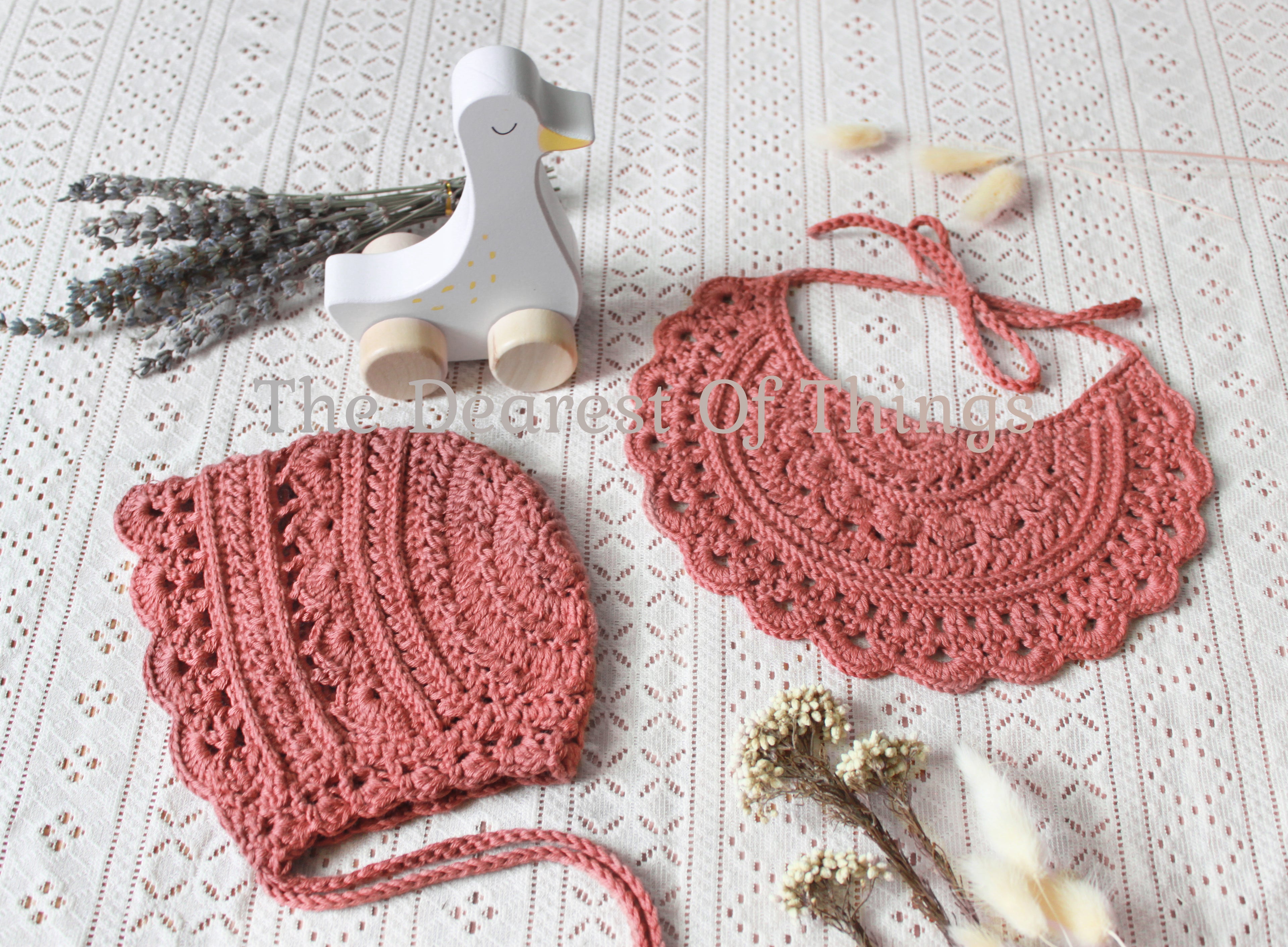 Mauve colored lace baby bib and bonnet set