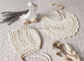 Cream colored crochet lace baby bib and bonnet set