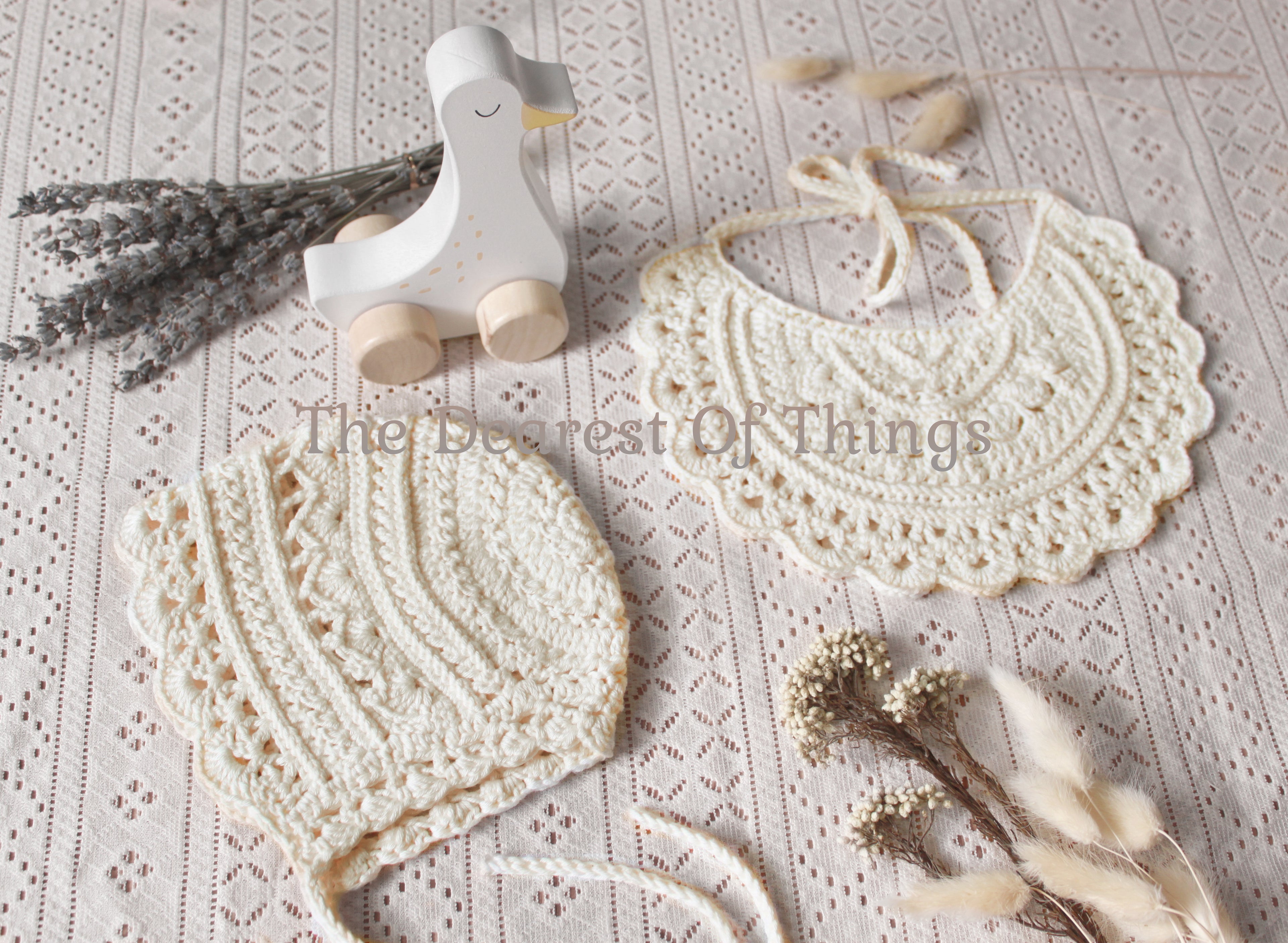 Cream colored crochet lace baby bib and bonnet set
